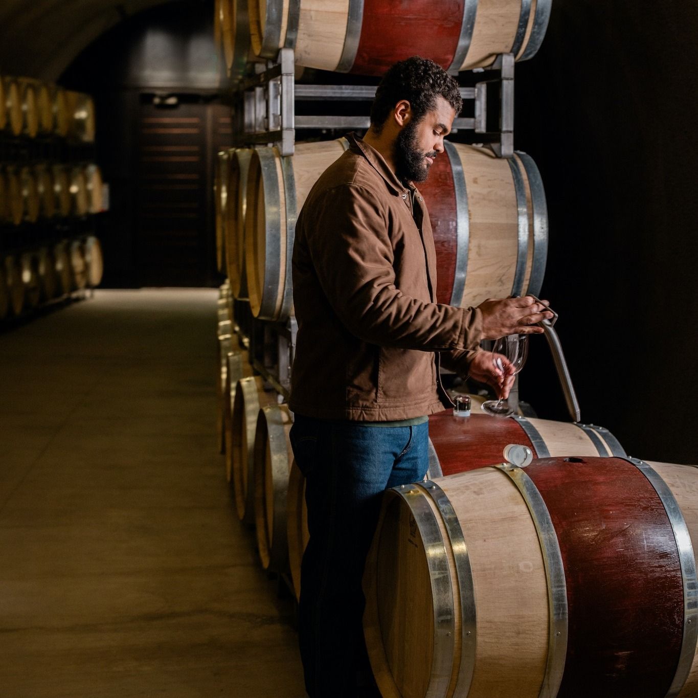 Winemaker Derek Baljeu pulling barrel samples in cellar