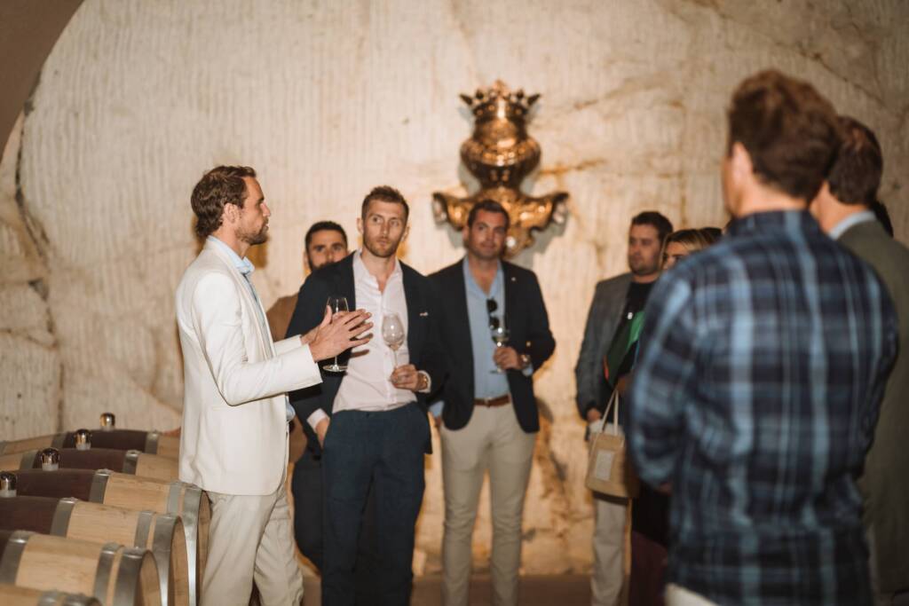 John Bailey guiding a group in the barrel cellar.