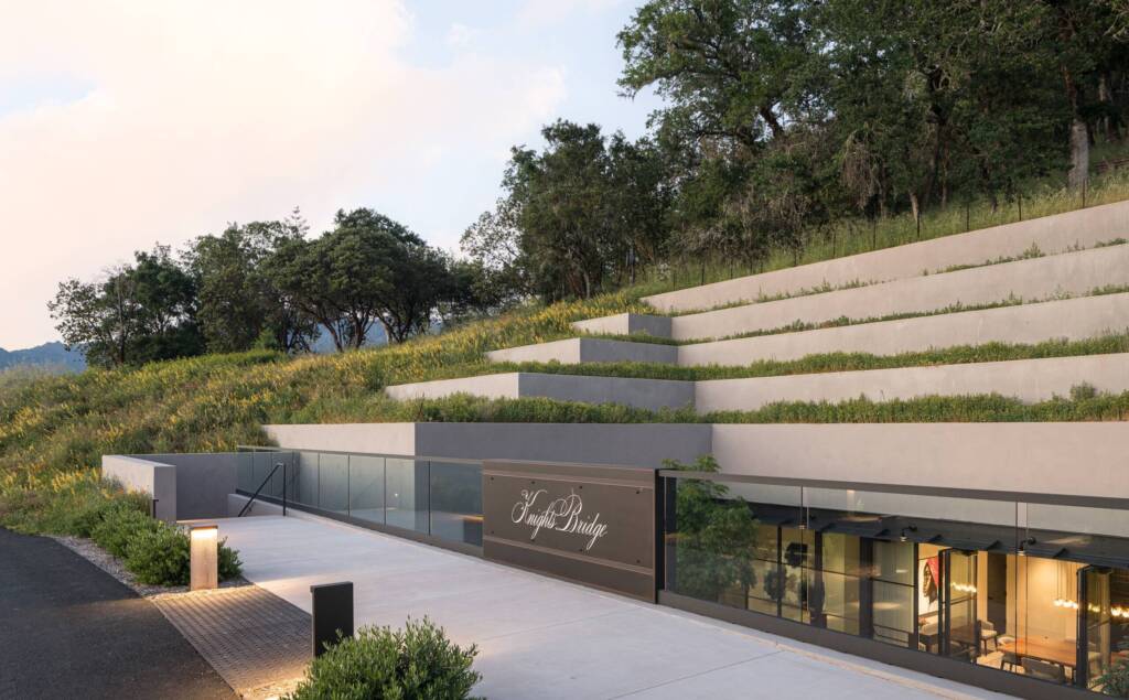 Terraced side of the Knights Bridge tasting room, showing how it is built into a hillside, with glass windows affording views inside at artwork.