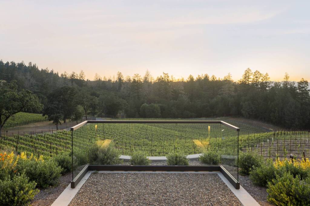 Dramatic view of vineyards from patio with gardens.