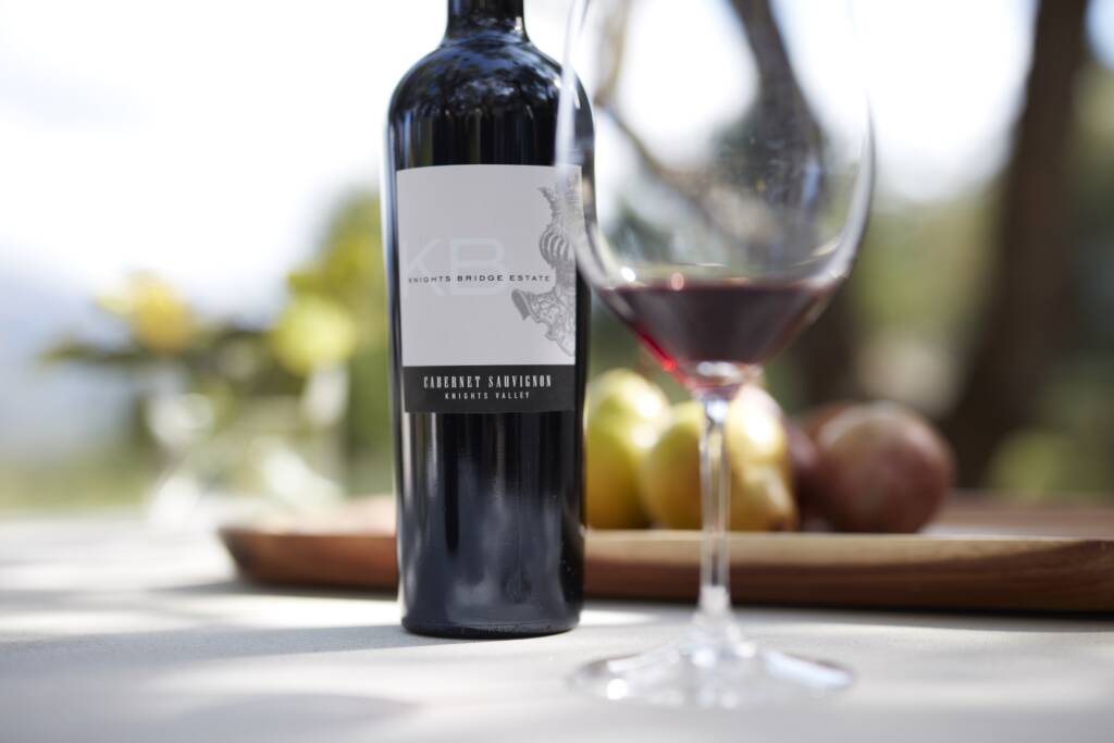 Close up of KB Cab Sauv and glass on outdoor table.