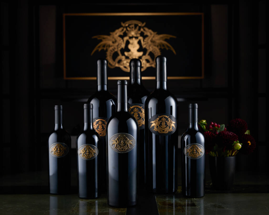 Full lineup of Draco Dormiere wines in dark lighting.